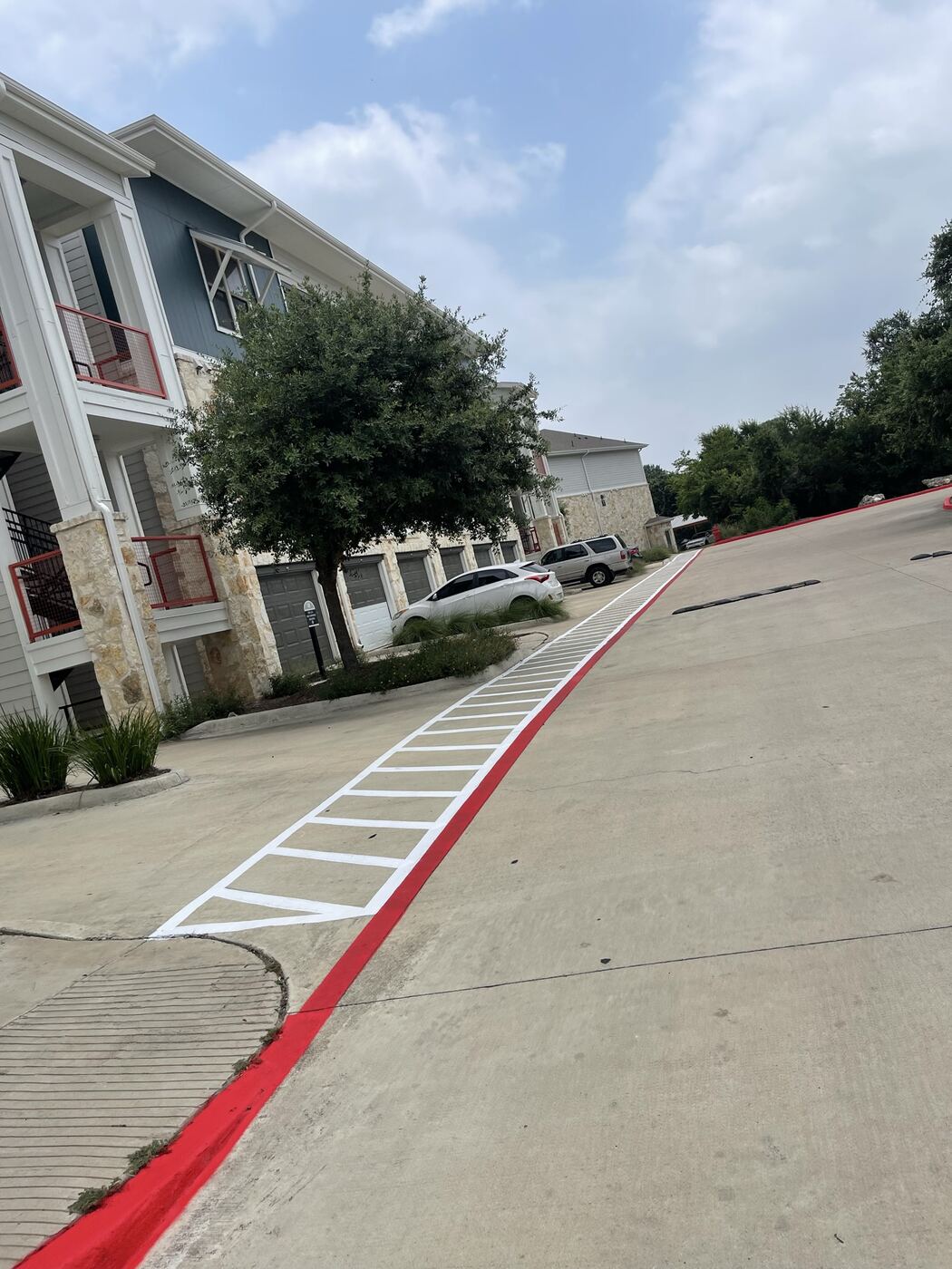 Red fire lane curb and ADA striping at an Austin apartment complex