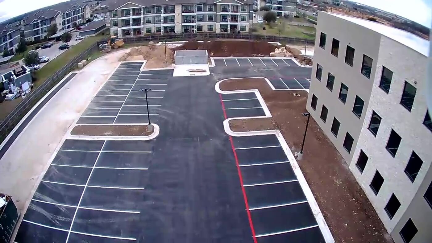 Aerial view of full parking lot restripe at apartment complex