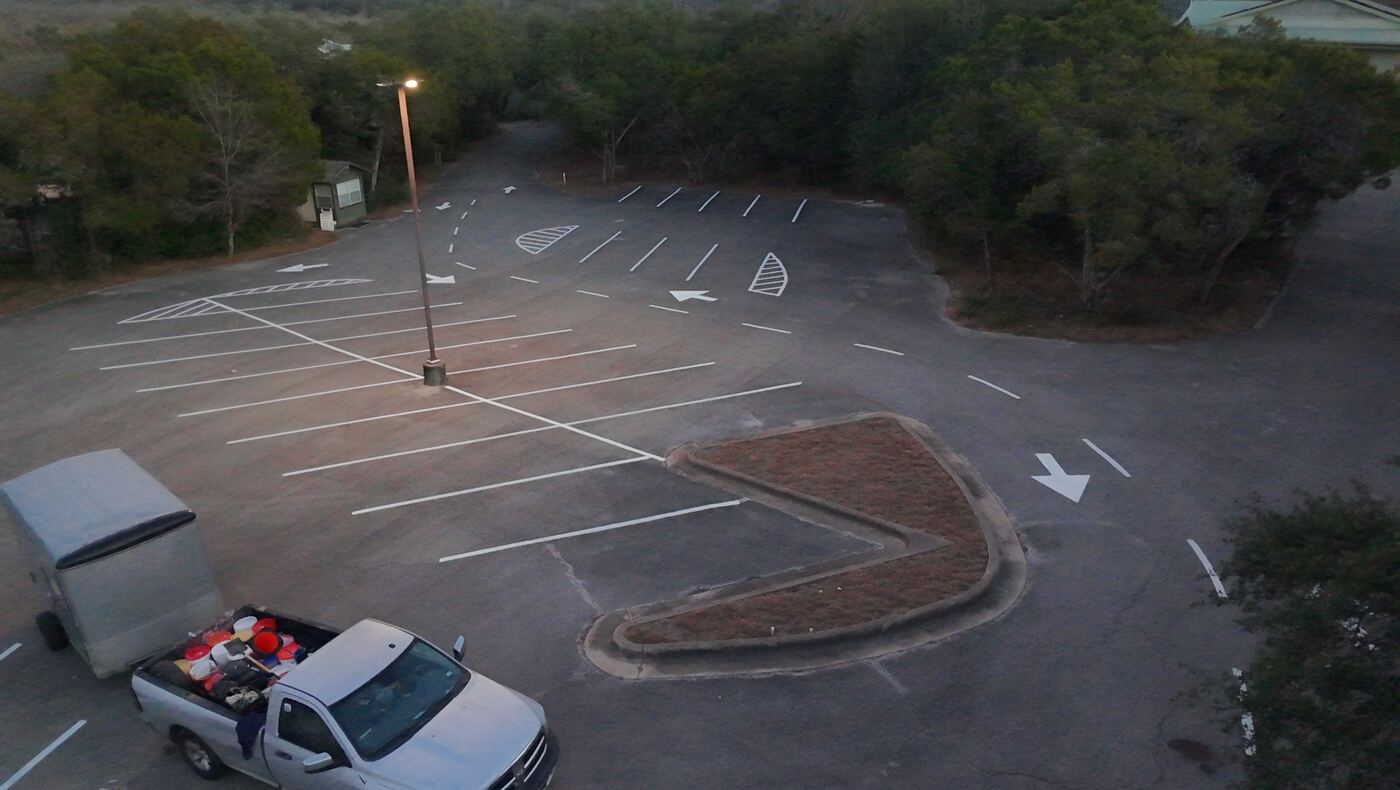 New parking lot layout with directional arrows and ADA markings